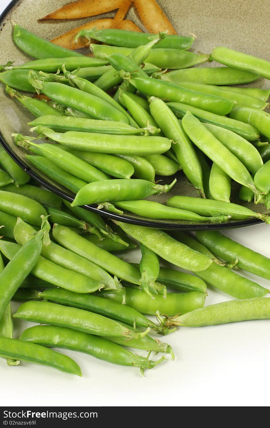 Delicious fresh green peas on white