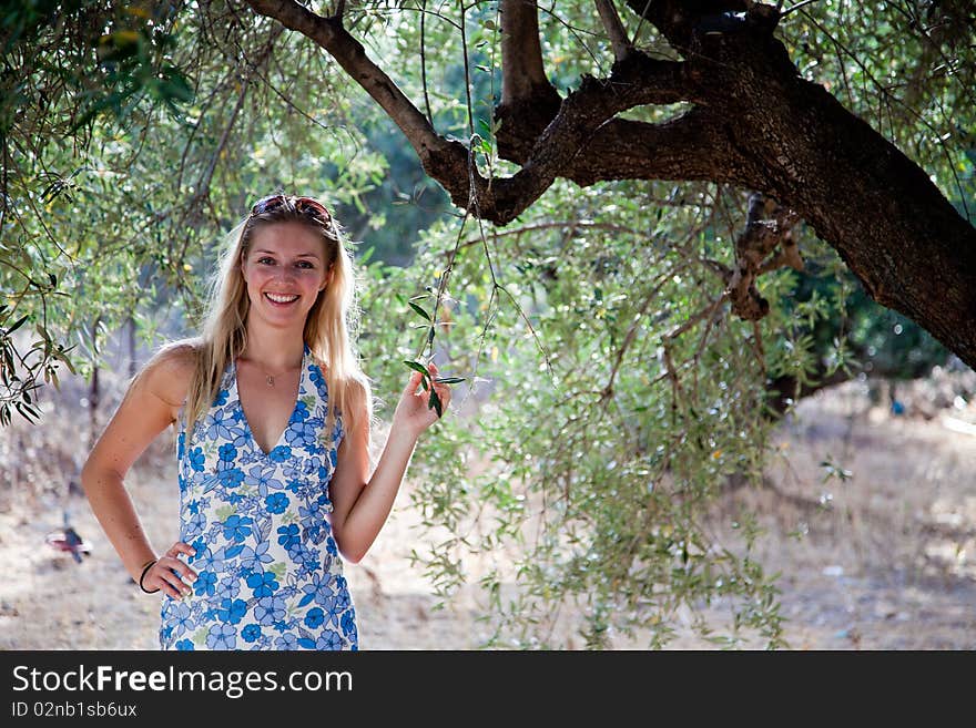 Young caucasian woman with olive trees