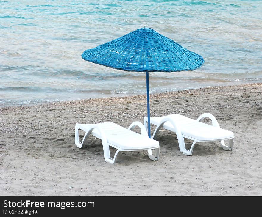 Sun-tent and two sun-beds on the beach