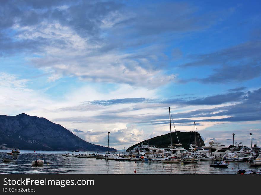 Boats and yachts moored in harbor at sunset. Boats and yachts moored in harbor at sunset.