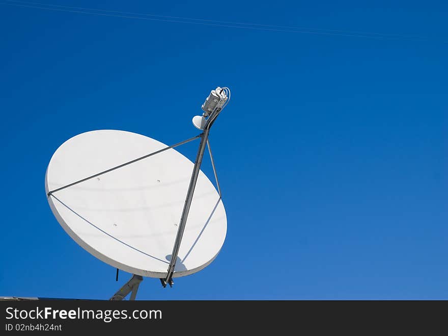 Parabolic antenna large white against the blue sky. Parabolic antenna large white against the blue sky