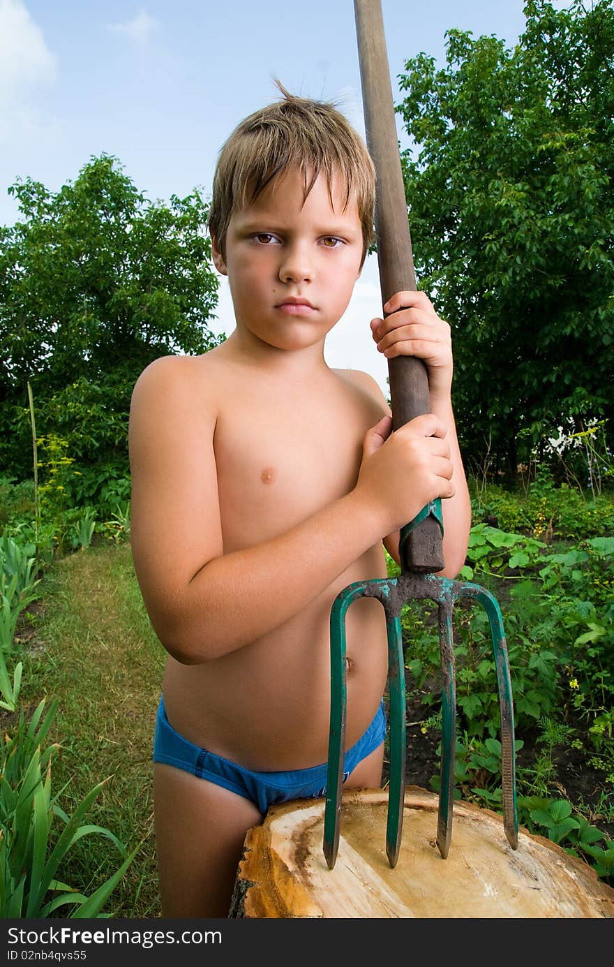 Serious boy with a pitchfork