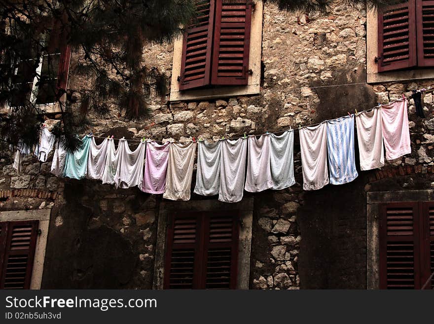 Towels on a linen against an old wall of the house. Towels on a linen against an old wall of the house.