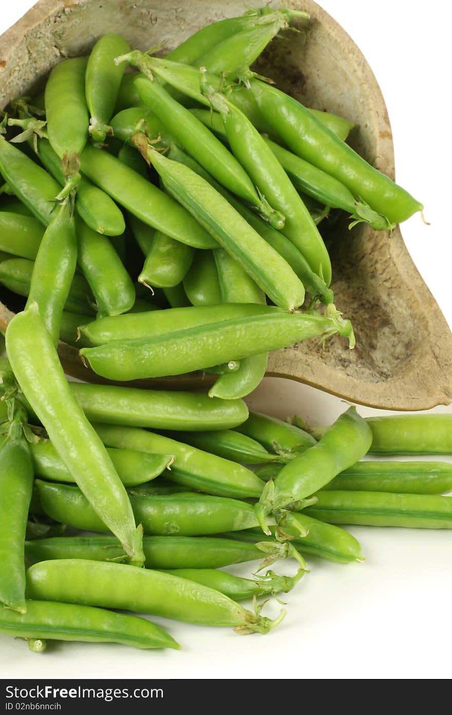 Delicious fresh green peas on white