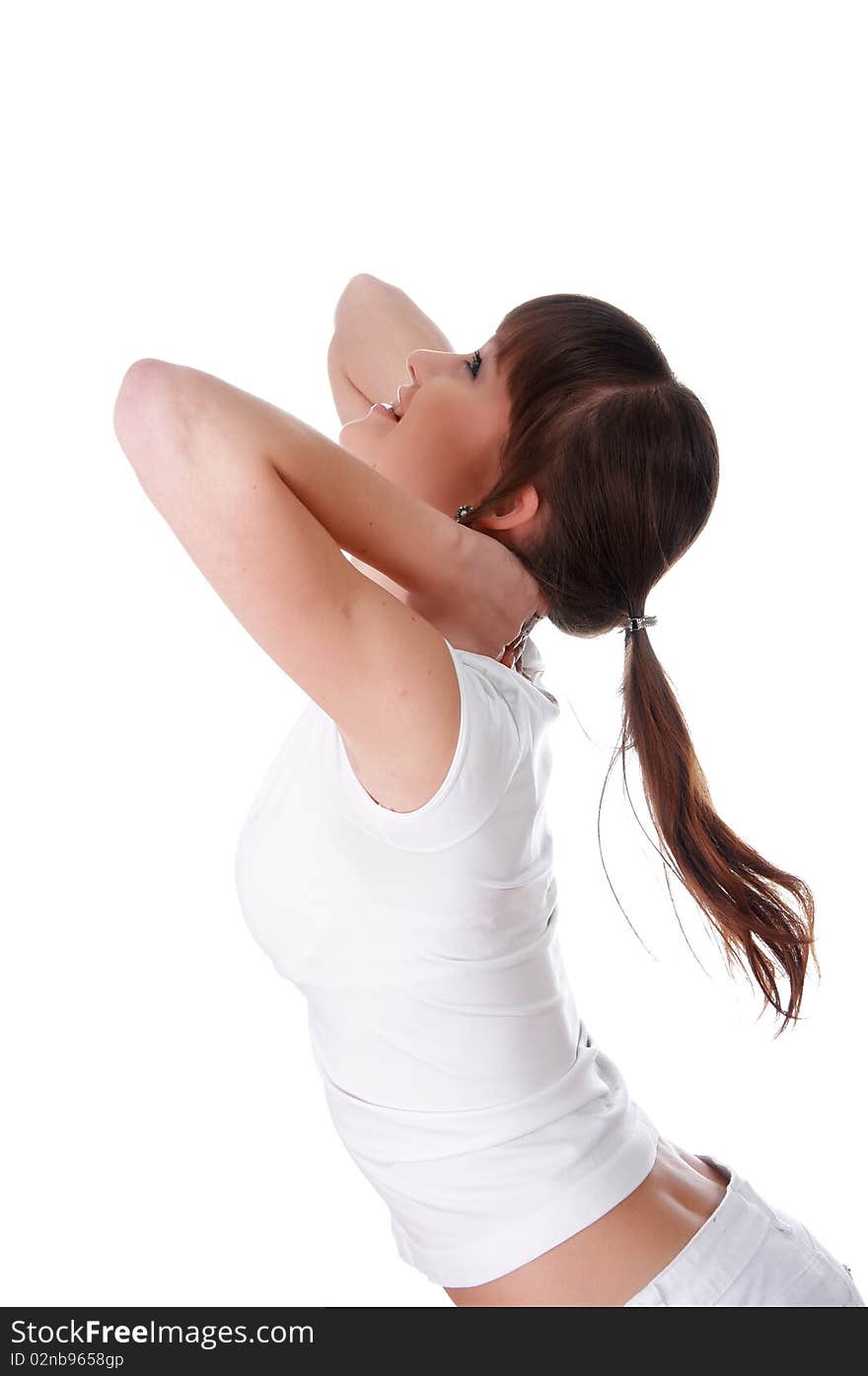 A charming young girl in a white T-shirt makes a sports exercise isolated on white