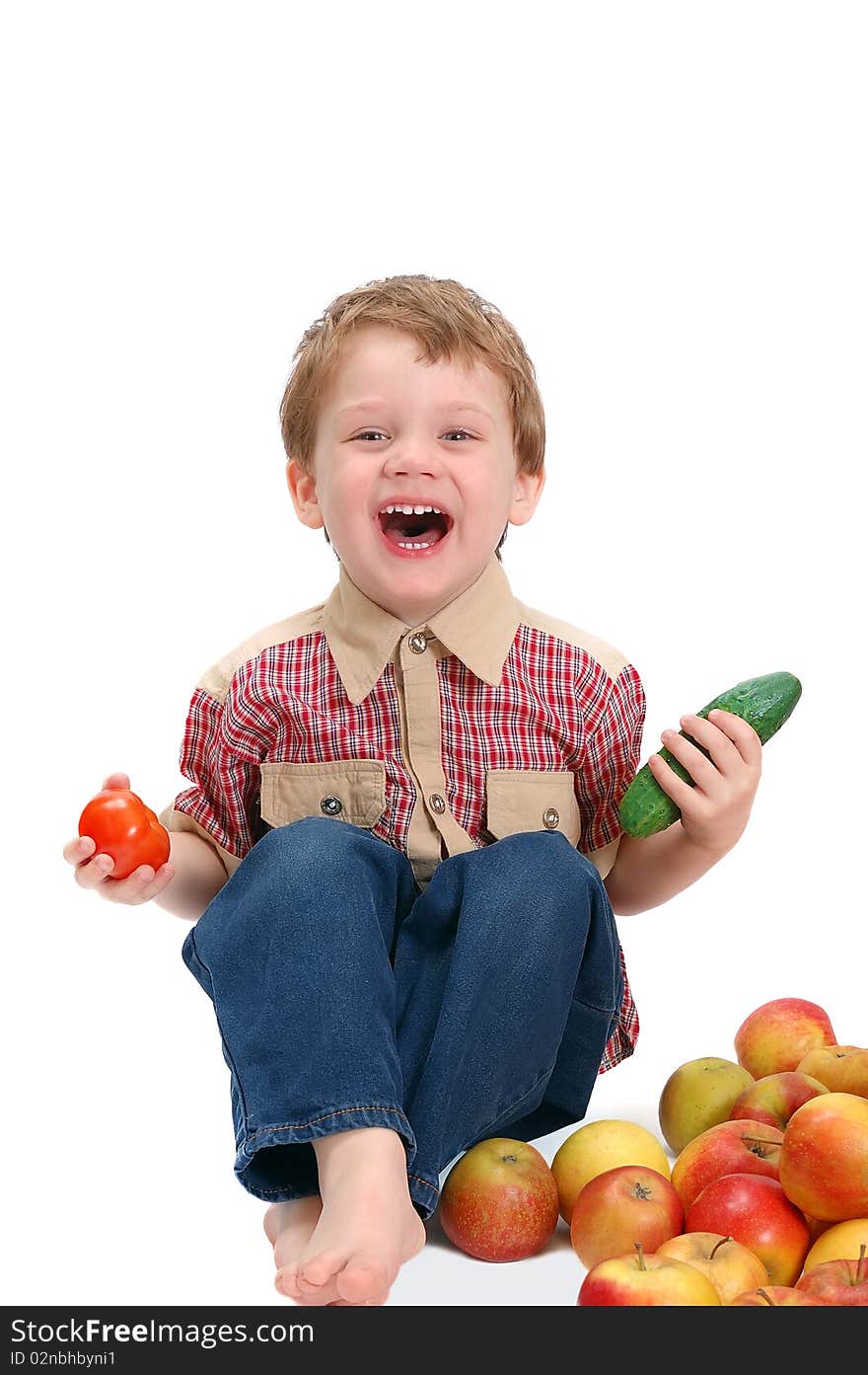 The little boy with fruit and vegetables isolated on white