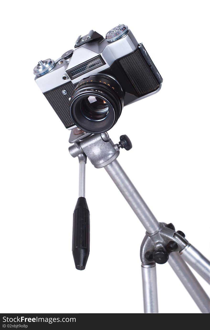 Old camera on tripod isolated on a white background