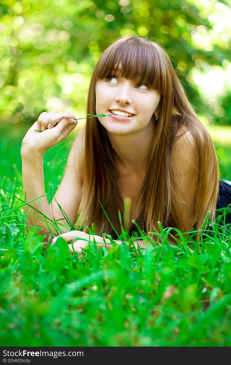 Portrait of the young girl on a lawn. Portrait of the young girl on a lawn.