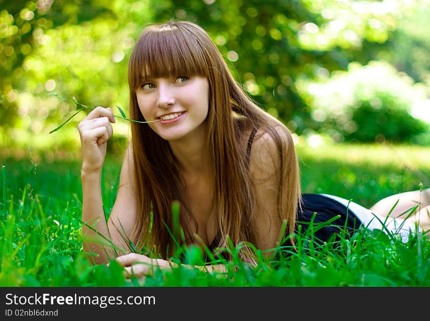 Portrait of the young girl on a lawn. Portrait of the young girl on a lawn.