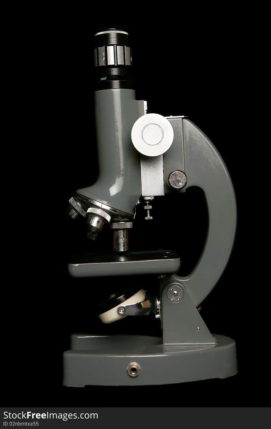 Microscope on black background in studio