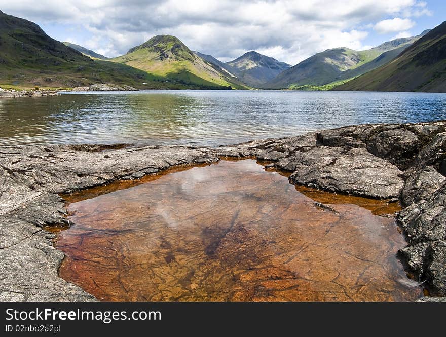 A rusty pool by a lake in the Lake District, England. A rusty pool by a lake in the Lake District, England.