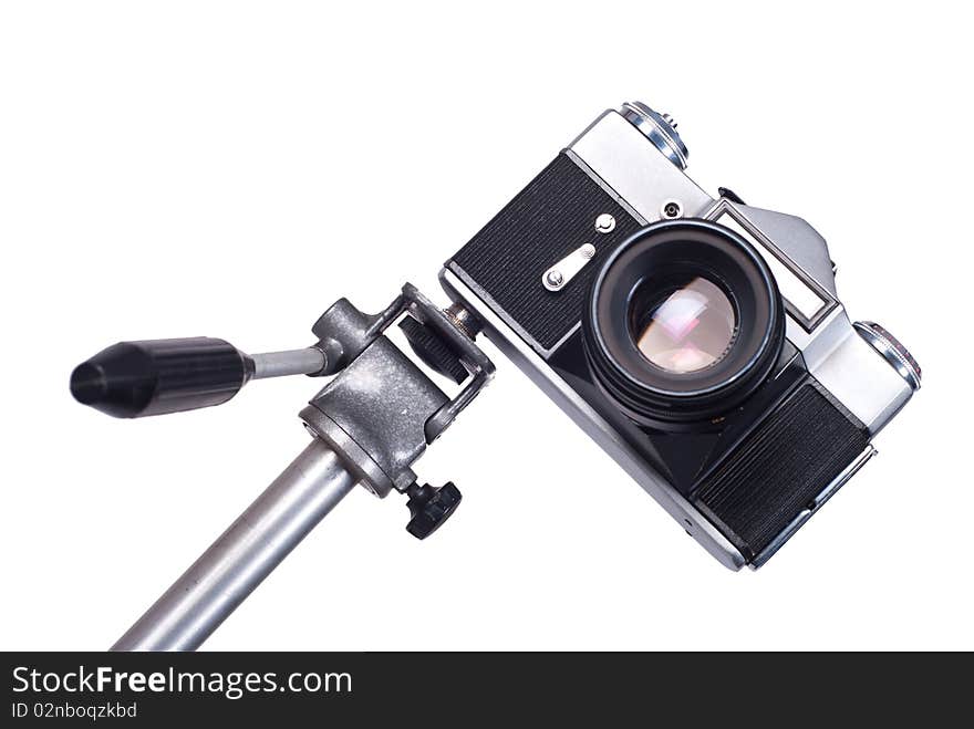 Old camera on monopod isolated on a white background