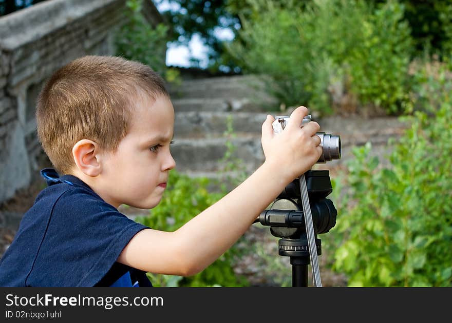 Little boy looks into focus the camera lens. Little boy looks into focus the camera lens