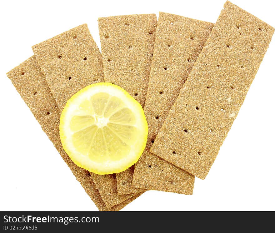 Crackling bread is spread out in the form of a fan, and on it the lemon segment lies. Crackling bread is spread out in the form of a fan, and on it the lemon segment lies