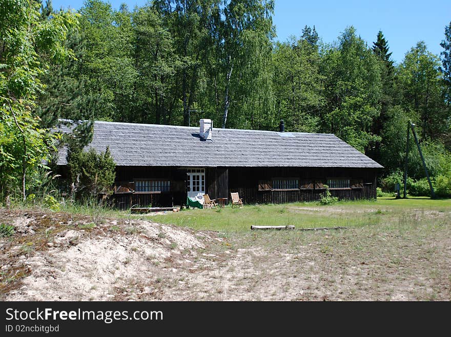 A wooden house owned by a fisherman close to the water front. A wooden house owned by a fisherman close to the water front