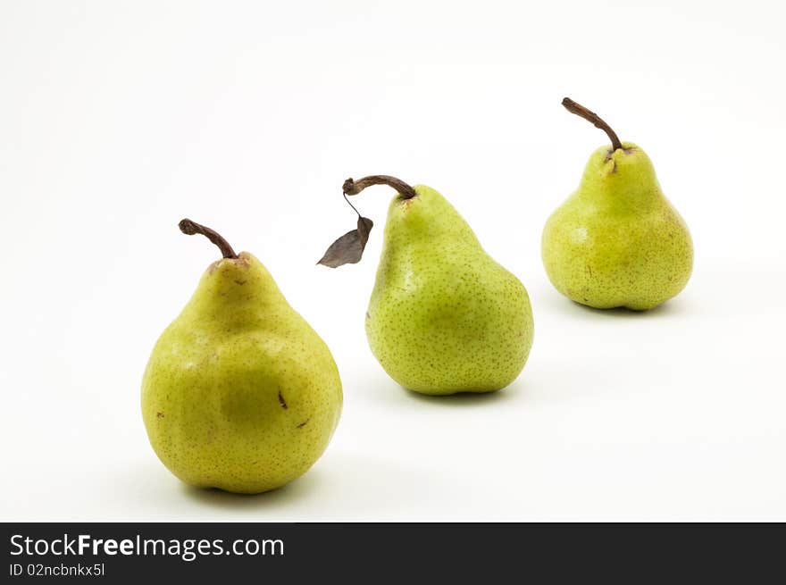 Three pears on white background with single leaf. Three pears on white background with single leaf