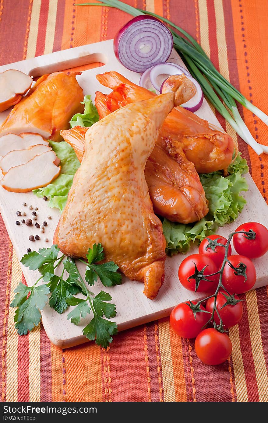 Meat smoked chicken on a wooden cutting board. Meat smoked chicken on a wooden cutting board.