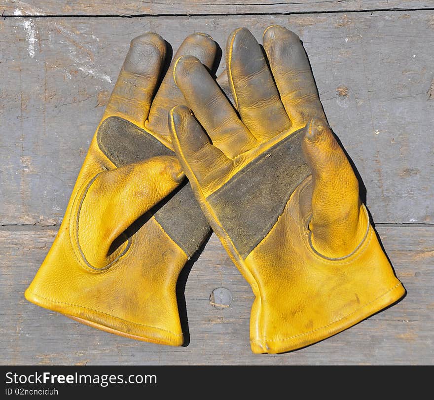 A gloved workman holding a rusty chain on a white background. A gloved workman holding a rusty chain on a white background