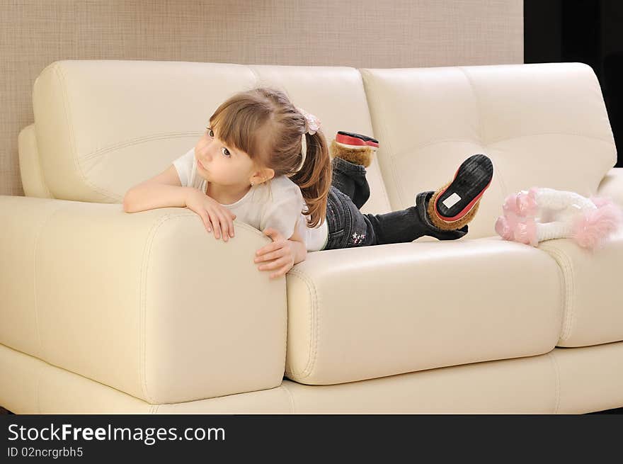 Beautiful young woman relaxing at moder home while working wireless on laptop computer. Beautiful young woman relaxing at moder home while working wireless on laptop computer