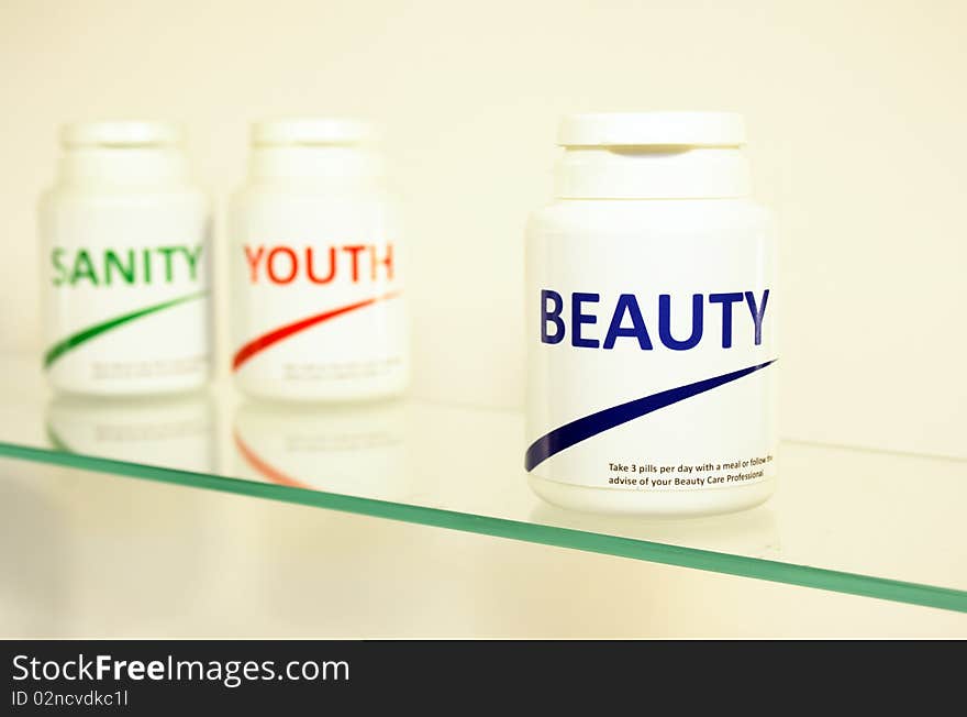 Sanity, Beauty and Youth pills in a bottle on bathroom shelf with focus on Beauty, fake brands