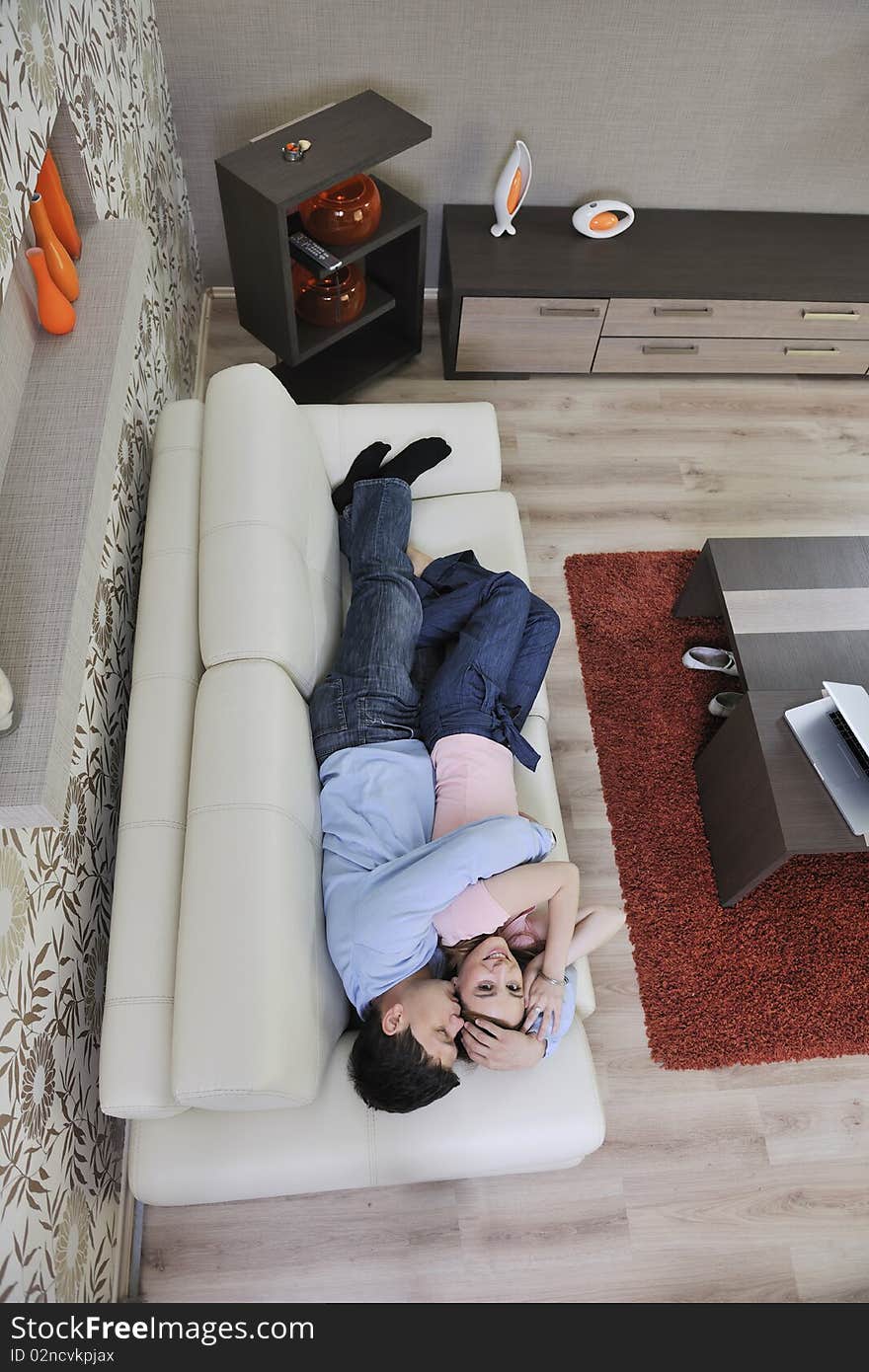 Couple relax at home on sofa in living room