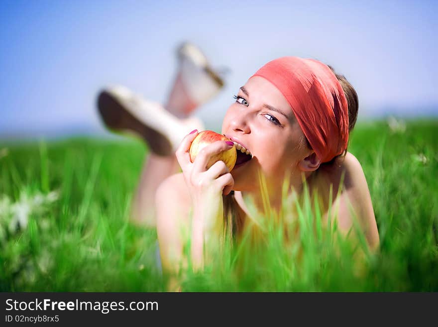 Nice girl in kerchief with apple