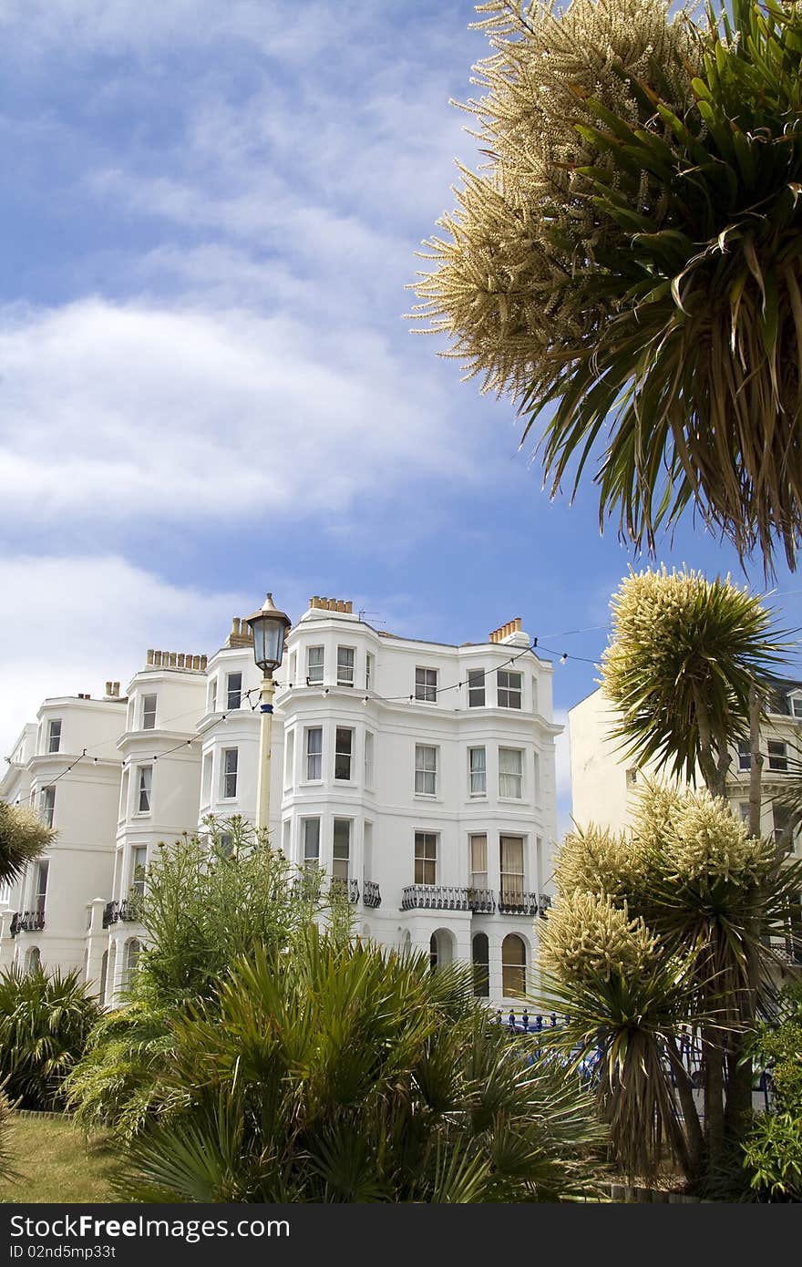 Exotic plants surround seafront hotel on sunny day in Eastbourne. Exotic plants surround seafront hotel on sunny day in Eastbourne