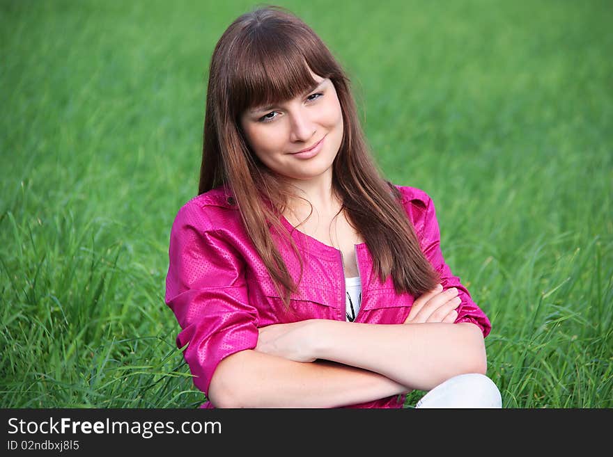 Smiling girl sitting in the grass