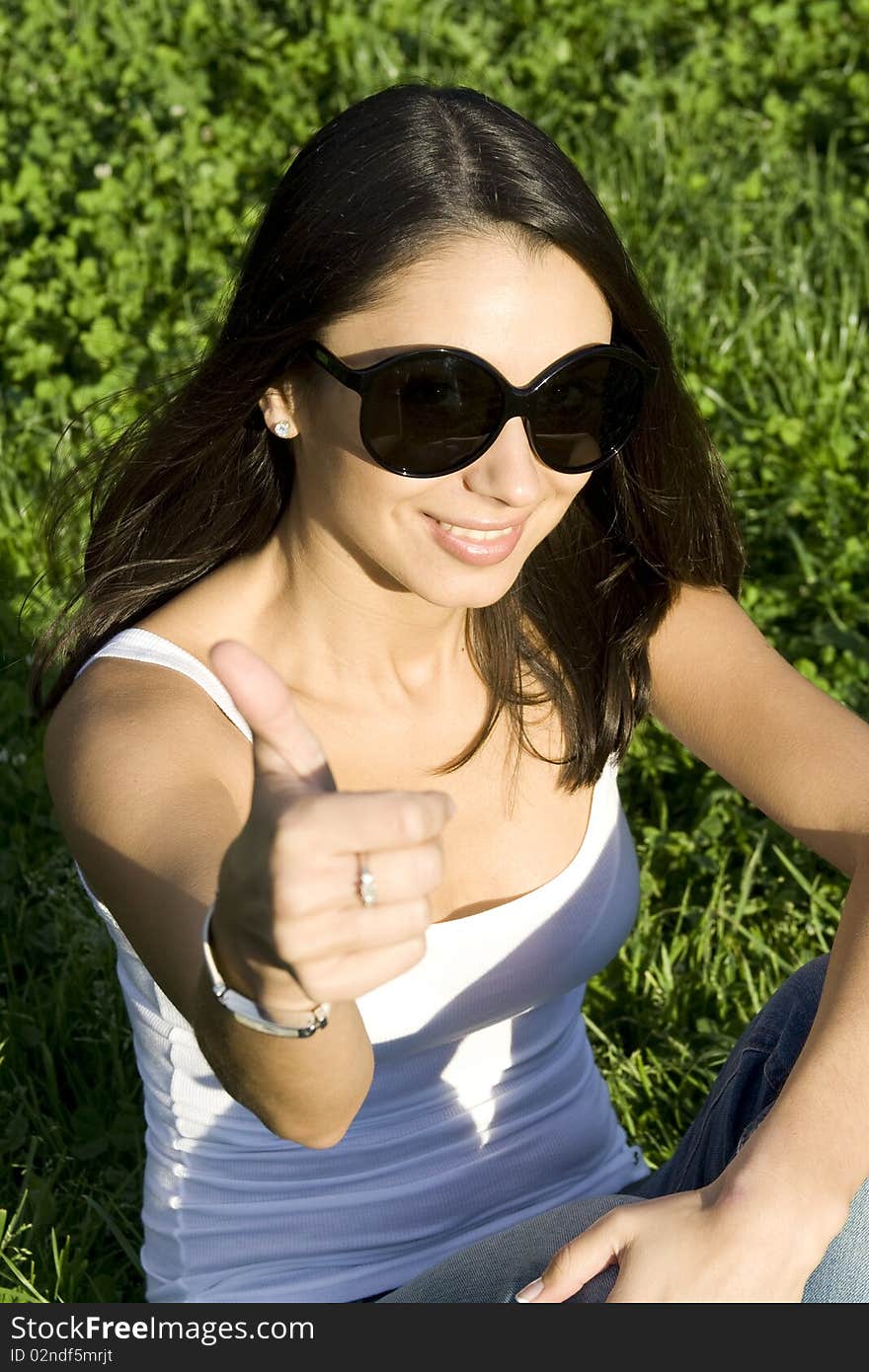 Beautiful young woman outdoors in nature. Portrait. Sign OK. Beautiful young woman outdoors in nature. Portrait. Sign OK