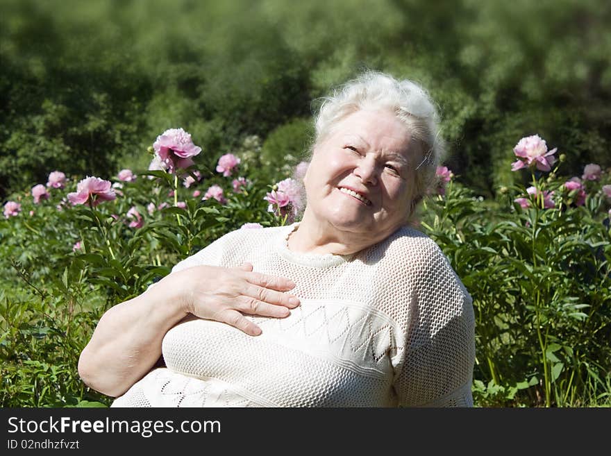 Senior woman enjoying the summer garden