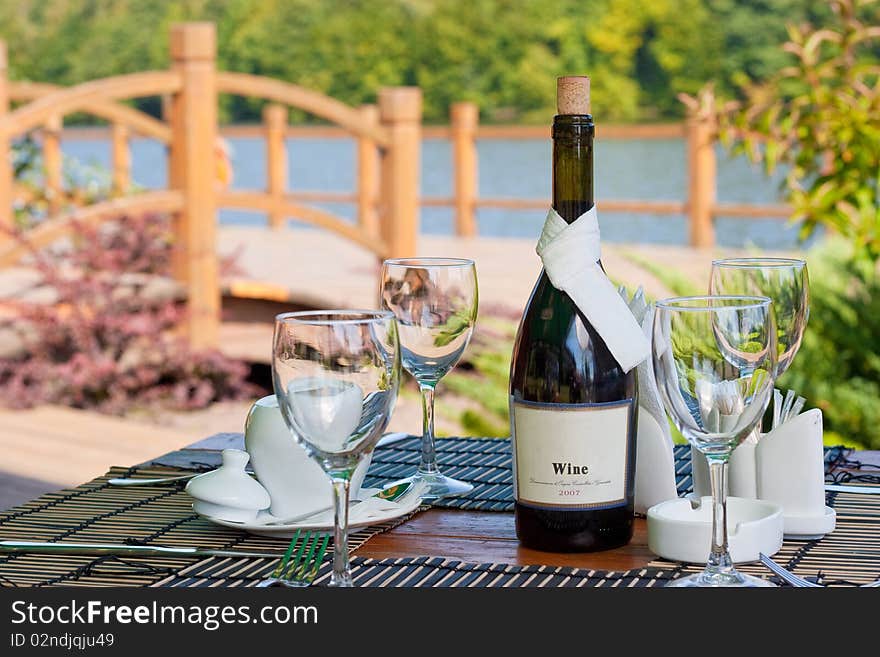 Beautiful served table in front of picturesque lake