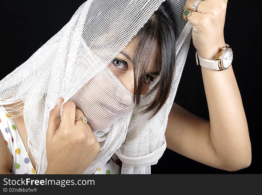 Arabian girl covering her face with white stole.