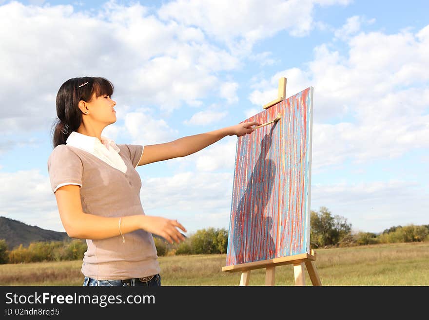 Woman painting landscape