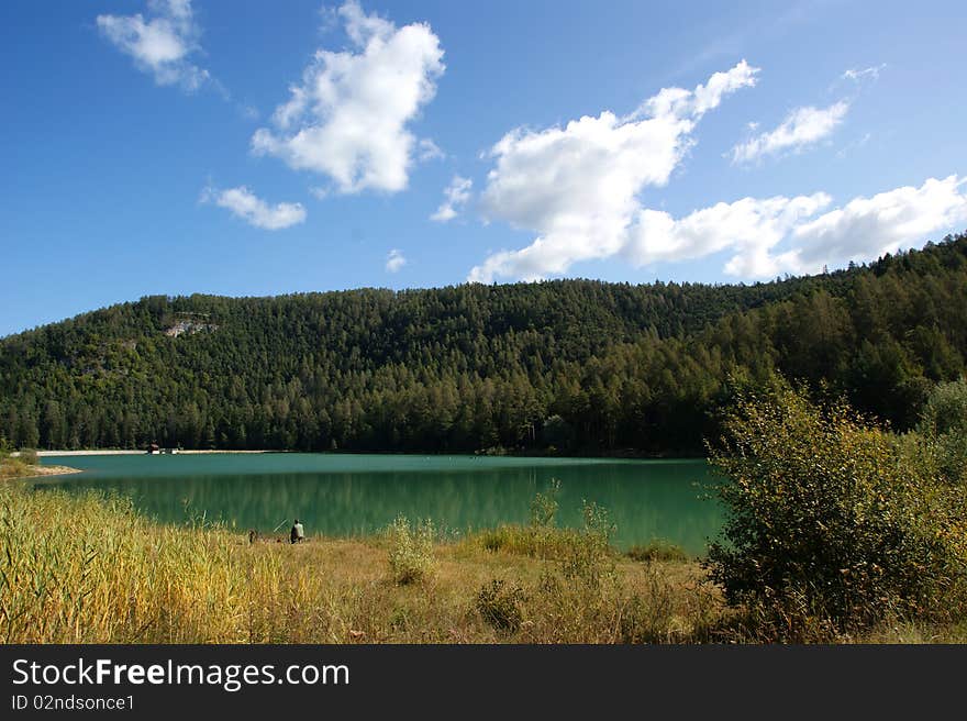 A view of the Alpine-South Tyrol with the background of emerald green lake. A view of the Alpine-South Tyrol with the background of emerald green lake.