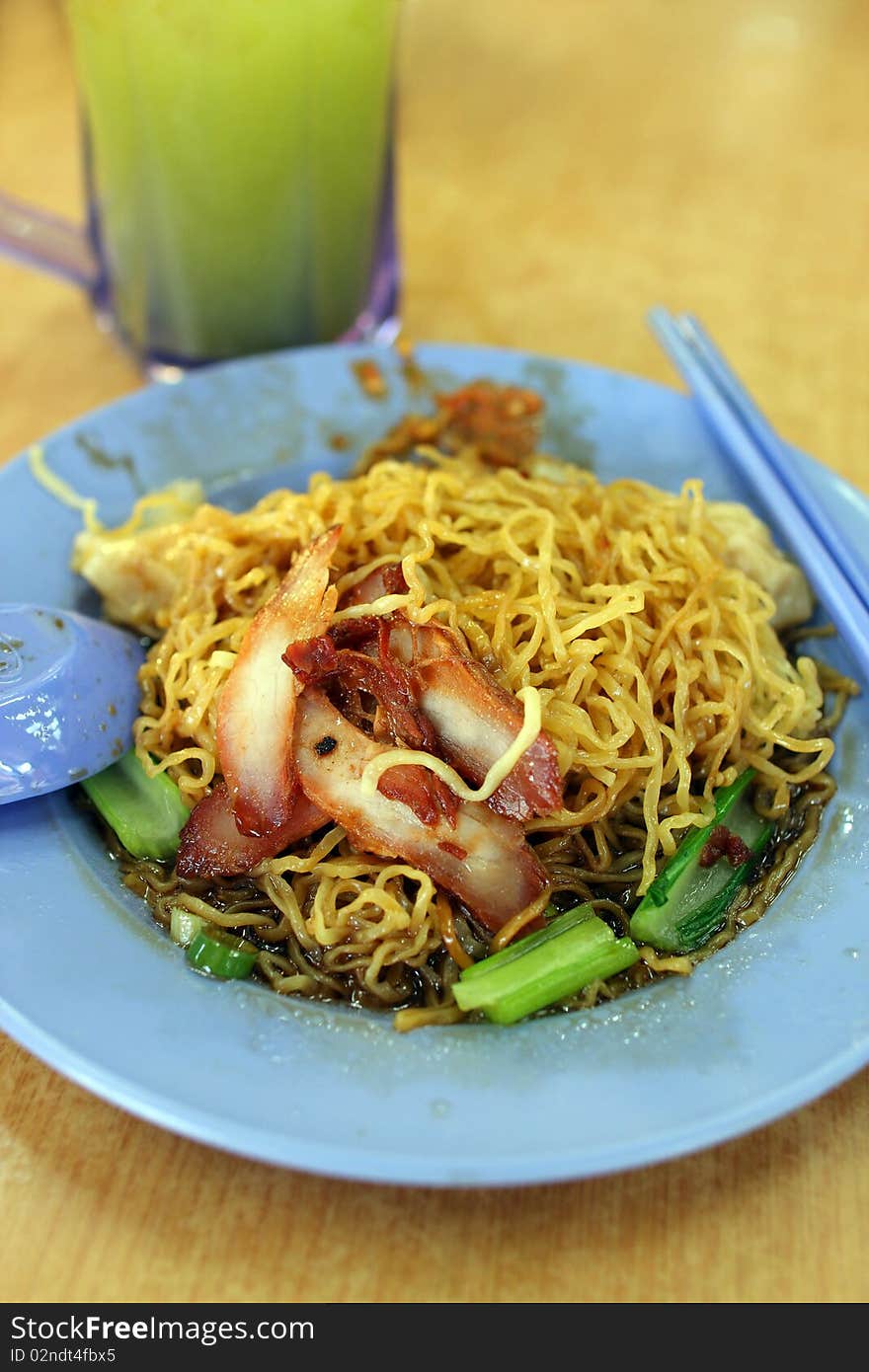 Closeup of wantan noodle (chinese noodles) with roasted pork meat.