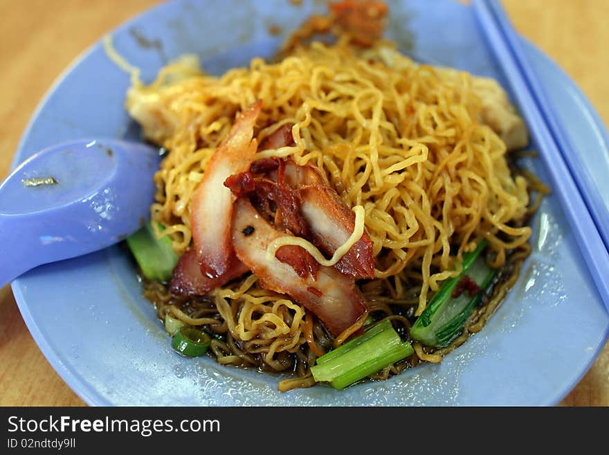 Closeup of wantan noodle (chinese noodles) with roasted pork meat.