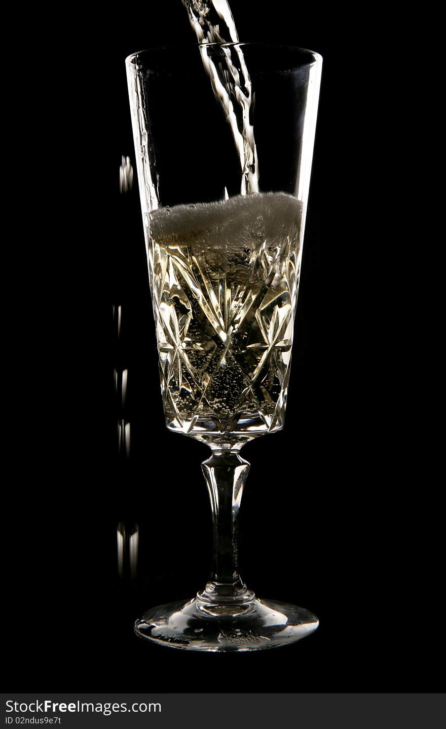 Champagne Being Poured In Crystal Glass