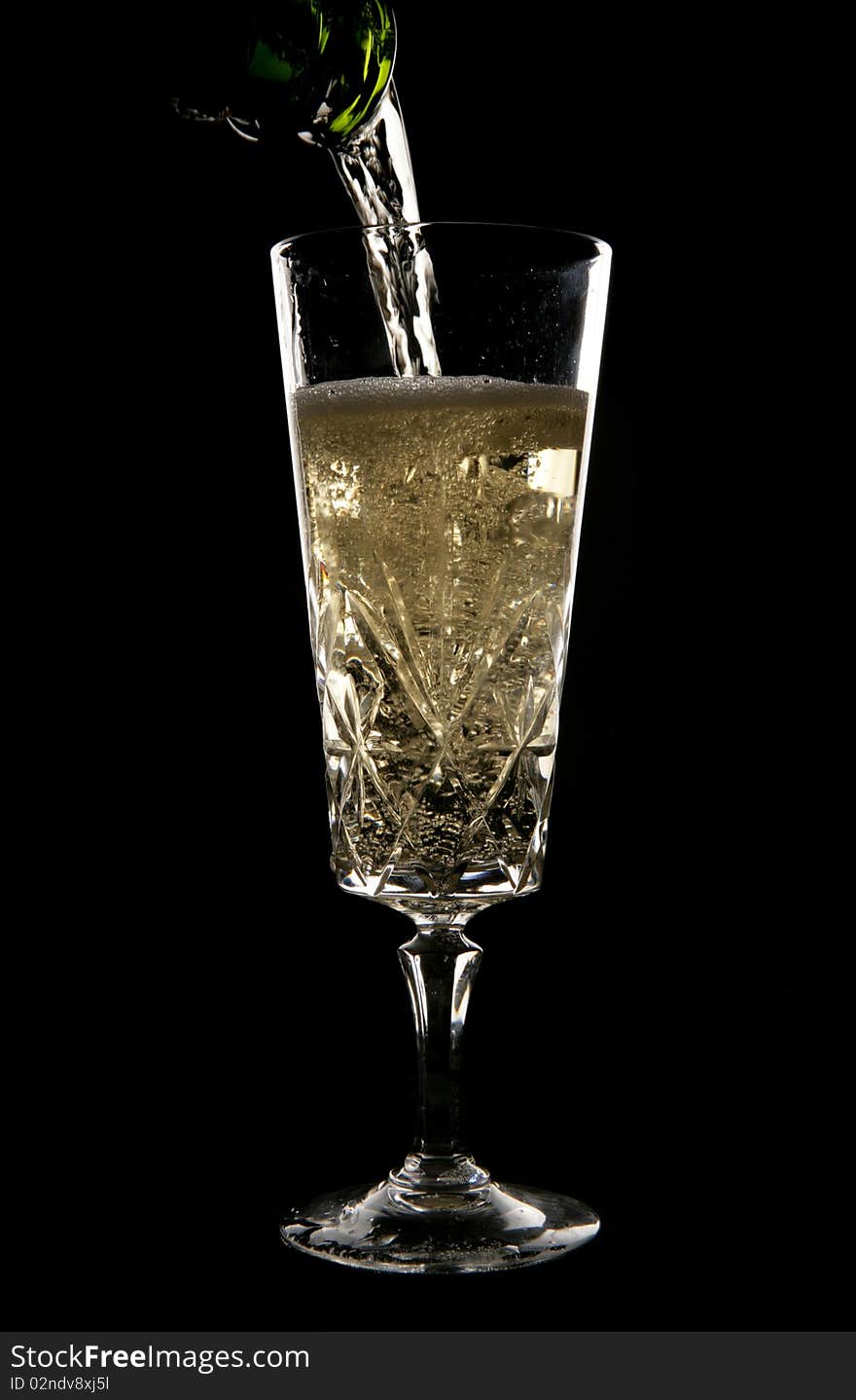 Champagne being poured in crystal glass in studio