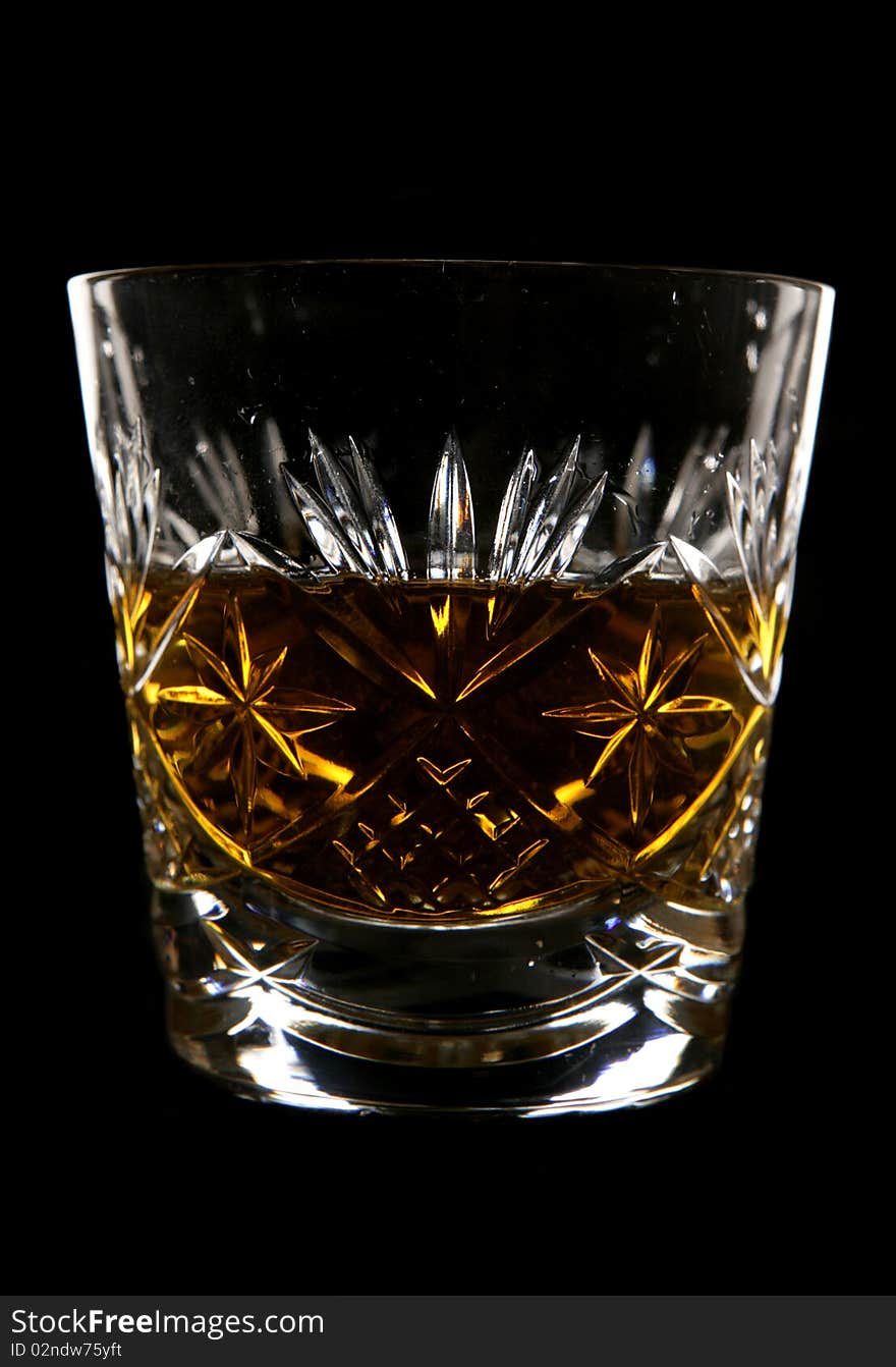 Whiskey in crystal glass in studio