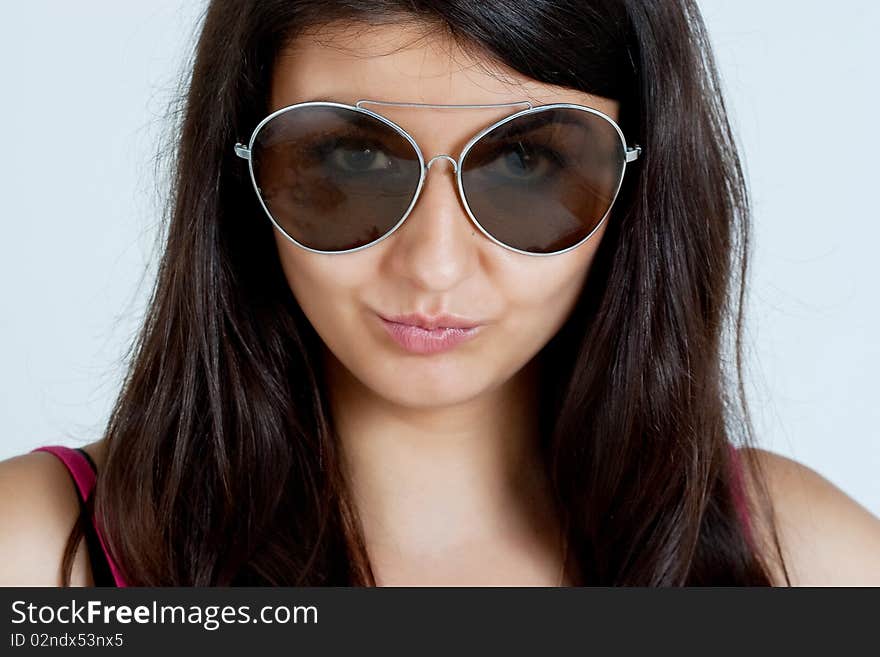 Fashion portrait of young pretty woman with glasses