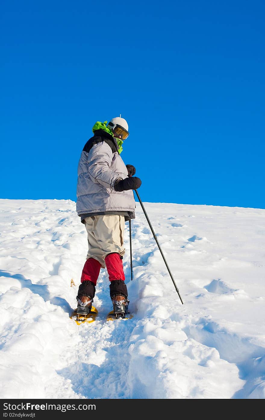 Hiker in winter in mountains