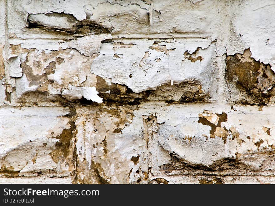 Peeling white paint on a cement wall looking grungy and old. Peeling white paint on a cement wall looking grungy and old.