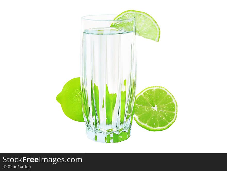 Glass of water with lime isolated on a white background