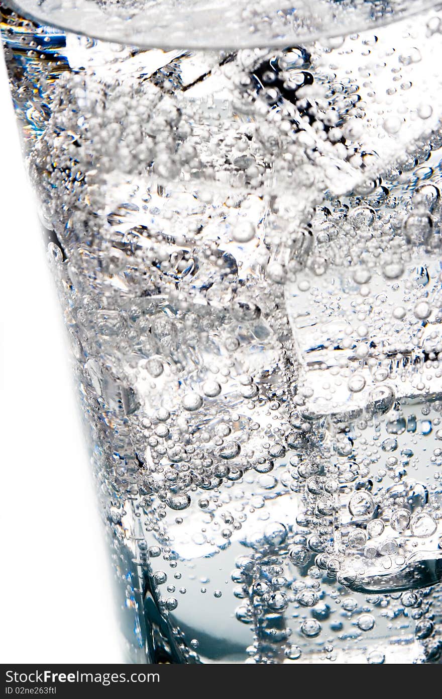 Macro image of ice cubes and water bubbles in a glass