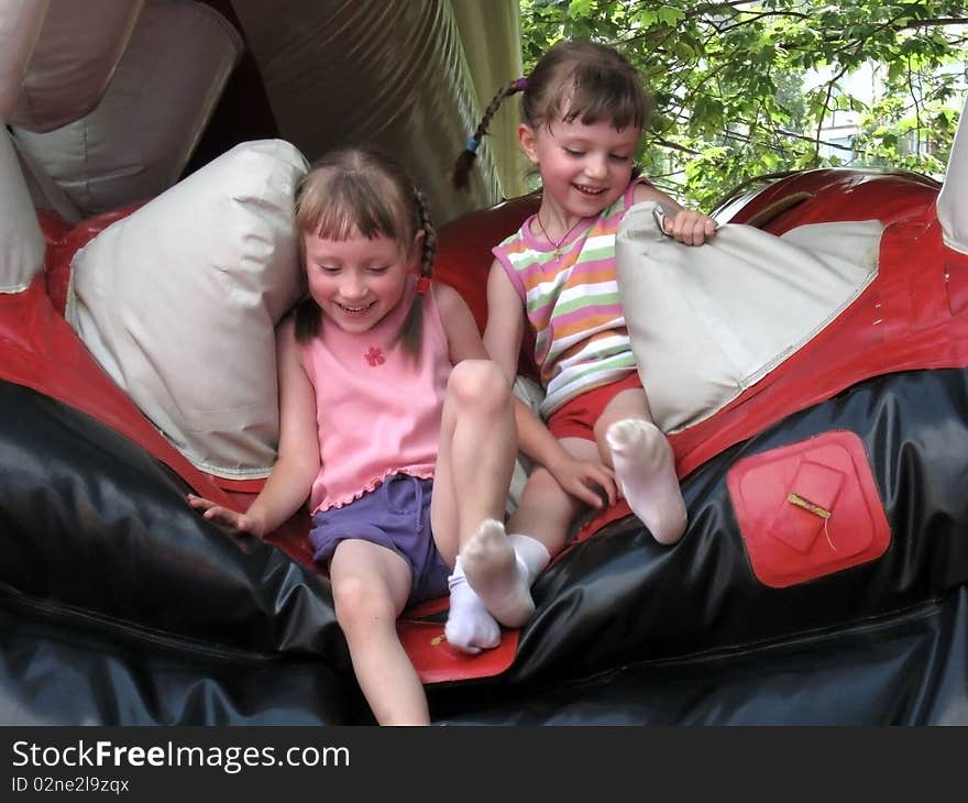 The photo shows children jumping on a trampoline