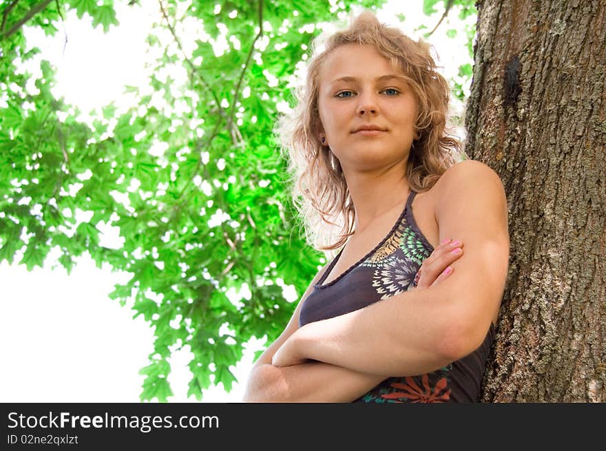 Young beautiful girl based on the tree and smiles. Young beautiful girl based on the tree and smiles.