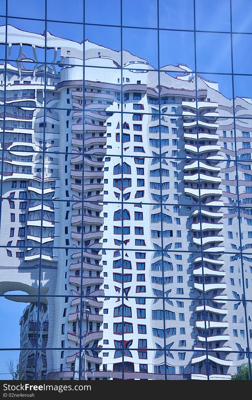 The building is reflected in mirror glasses. The building is reflected in mirror glasses.