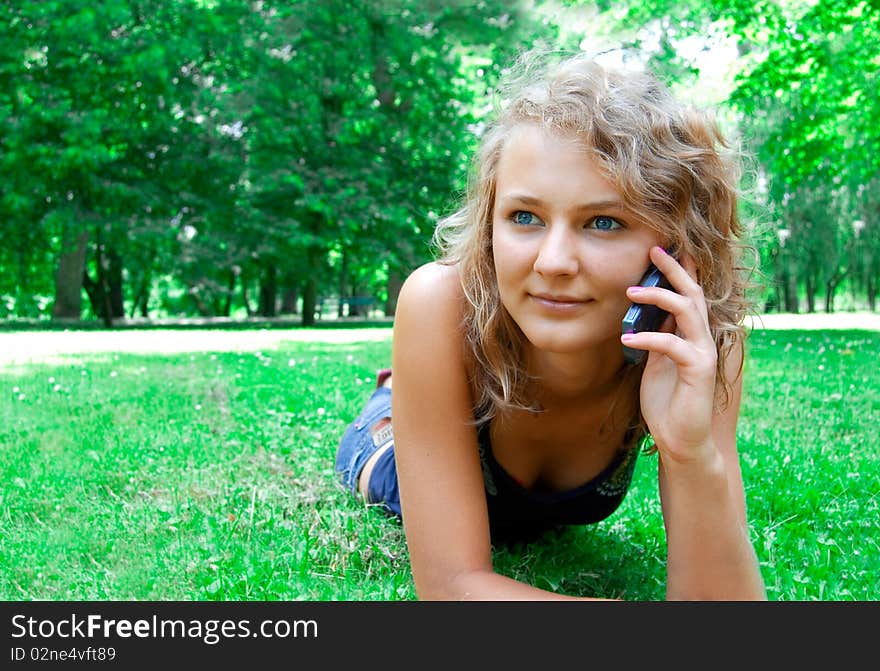 Communication conceptual image. Young beautiful girl talking on a cell phone.