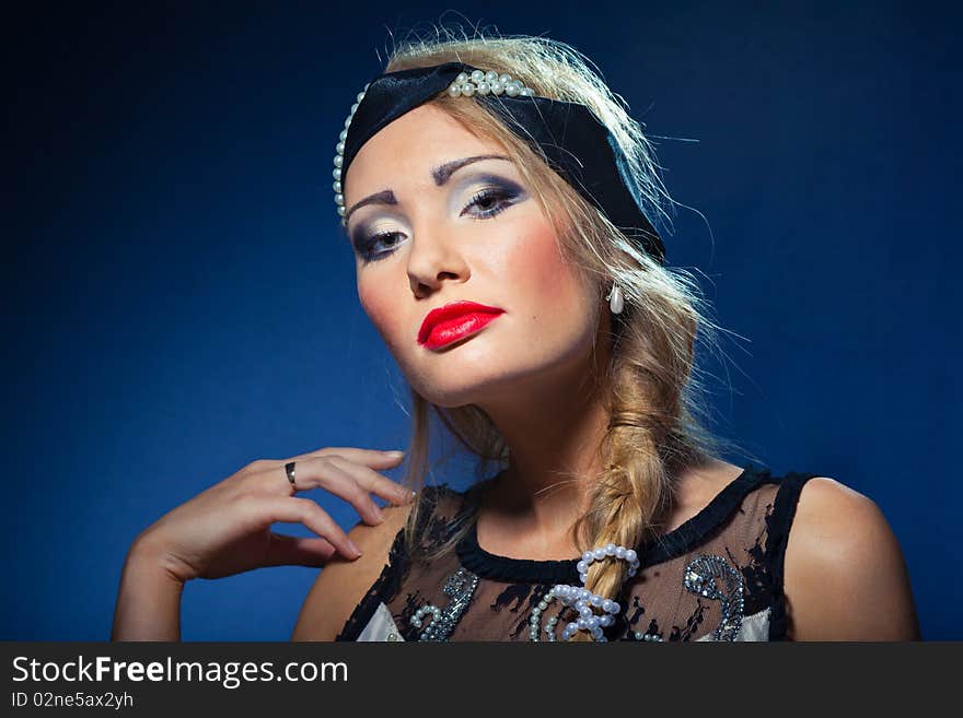 Portrait of attractive retro-style girl in bonnet over black