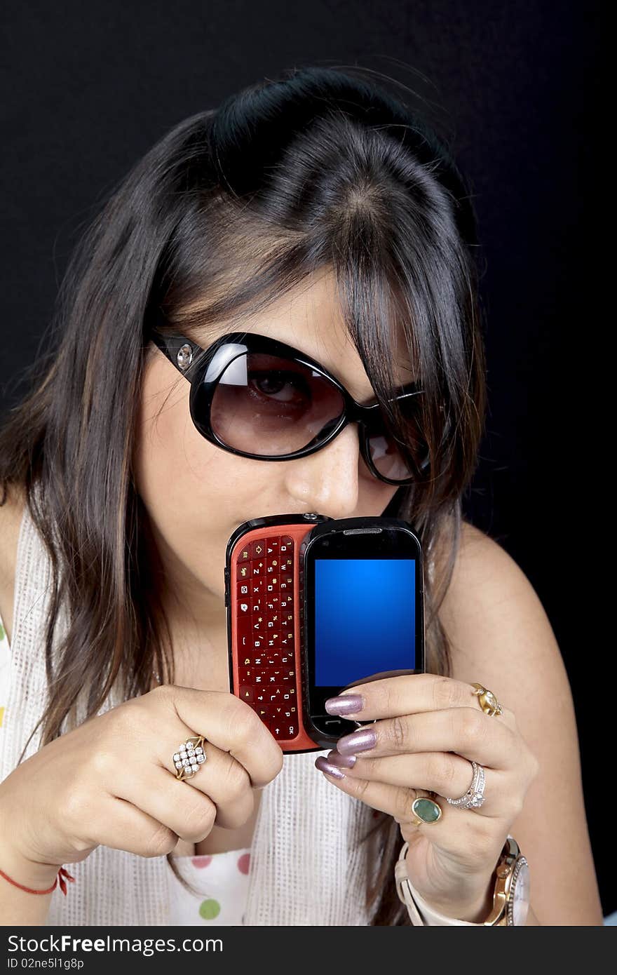 Girl showing multimedia phone in her hand. Girl showing multimedia phone in her hand.